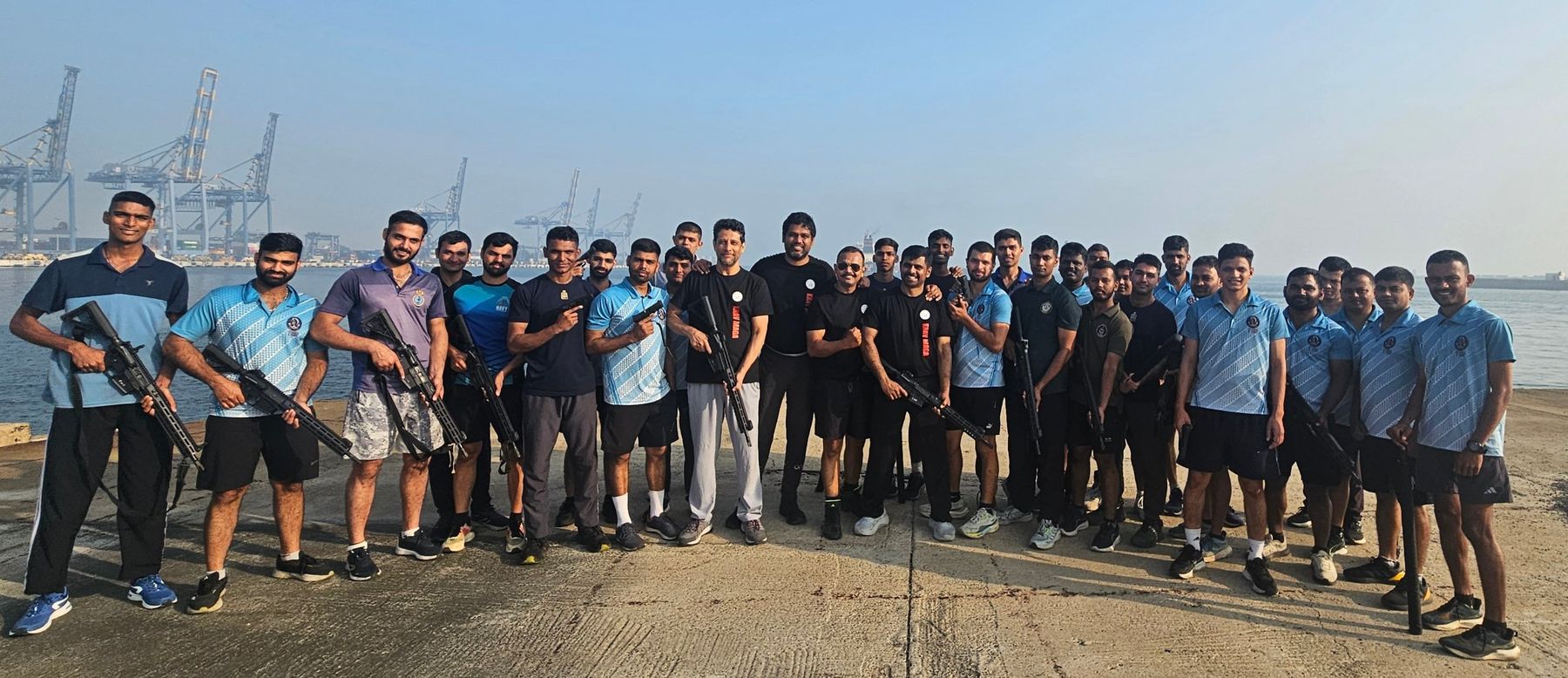 Sailors and officers with Raw Krav Maga instructors after a training session on a naval pier