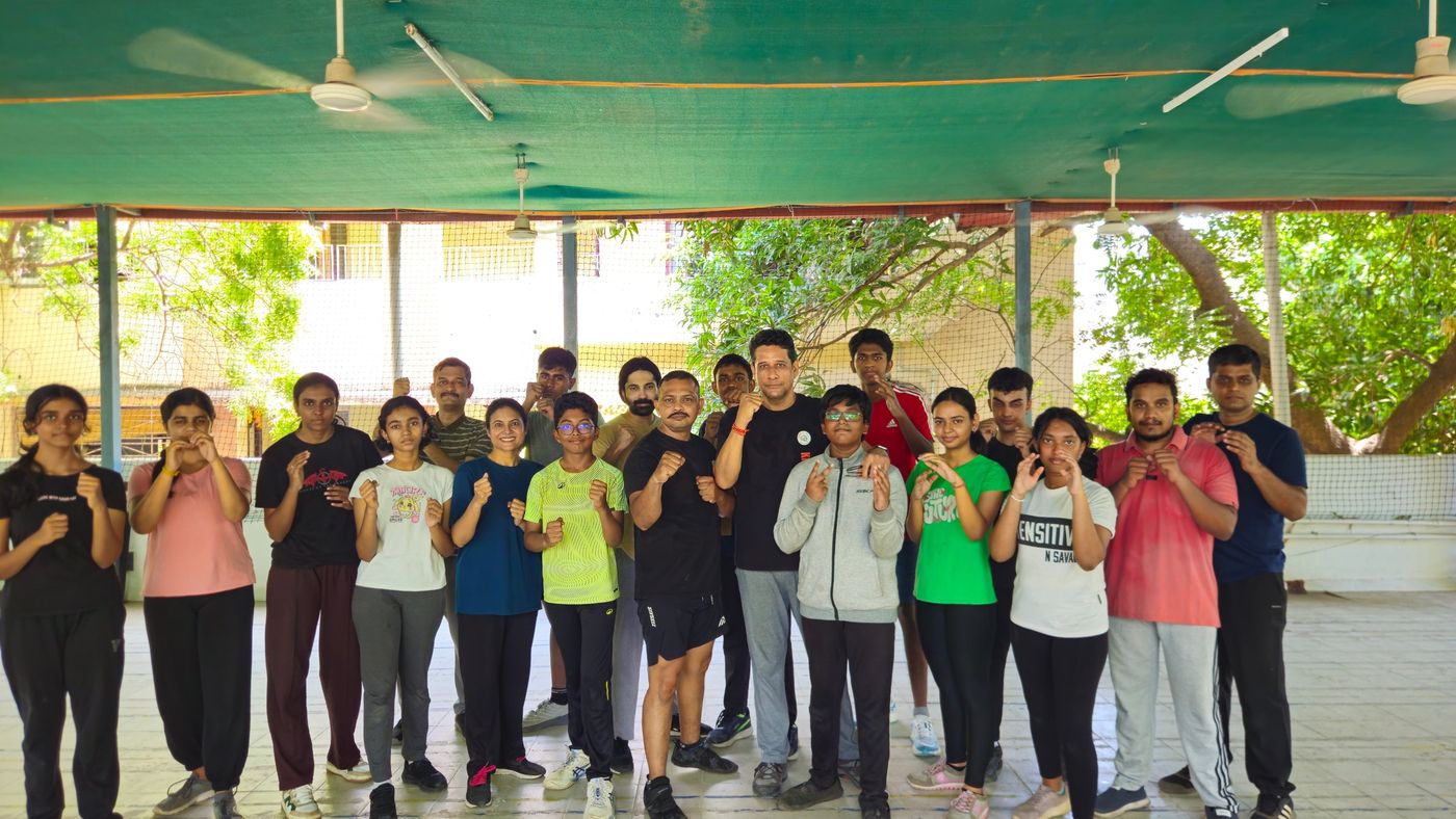Krav Maga weekend class participants, teenagers and adults, in guard stance with their instructor
